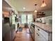 Updated kitchen with stainless steel appliances, granite counters, and white cabinets providing ample storage and countertop space at 329 Highland Dr, Lincolnton, NC 28092