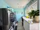 Modern laundry room with stainless steel washer and dryer, counter space and natural light at 329 Highland Dr, Lincolnton, NC 28092