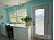 Well-lit laundry room area featuring ample counter space, natural lighting and convenient outdoor access at 329 Highland Dr, Lincolnton, NC 28092