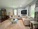 Bright living room featuring two sofas, a round coffee table, and a large TV mounted on the wall at 329 Highland Dr, Lincolnton, NC 28092