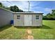 Exterior view of a small storage shed, with a simple design and a concrete tile pathway at 329 Highland Dr, Lincolnton, NC 28092