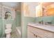 Dated bathroom featuring a toilet, tub and a sink; peeling wall paper at 3526 Craig Ave, Charlotte, NC 28211