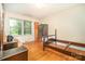 Bedroom with hardwood floors, a large window, and classic decor at 3526 Craig Ave, Charlotte, NC 28211