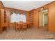 Cozy dining room features wood paneling, built-in shelves, and a classic dining set at 3526 Craig Ave, Charlotte, NC 28211