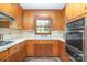 Classic kitchen with wooden cabinets, white countertops, and built-in oven at 3526 Craig Ave, Charlotte, NC 28211