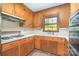 Vintage kitchen featuring wood cabinets, white countertops, and retro appliances at 3526 Craig Ave, Charlotte, NC 28211