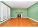 Bright living room featuring a cozy fireplace and hardwood floors at 3526 Craig Ave, Charlotte, NC 28211