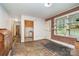 Room featuring brick wall and door leading into a kitchen area at 3526 Craig Ave, Charlotte, NC 28211