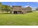 Expansive backyard with a brick home, a deck with an umbrella, and a covered parking or storage area underneath the deck at 3998 Holly Springs Dr # 20, Newton, NC 28658