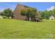 Large backyard with green grass and mature trees at 3998 Holly Springs Dr # 20, Newton, NC 28658