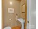 Charming powder room featuring a pedestal sink and hardwood floors at 3998 Holly Springs Dr # 20, Newton, NC 28658