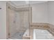 A tiled shower next to soaking tub provides luxurious convenience in this primary bathroom at 3998 Holly Springs Dr # 20, Newton, NC 28658