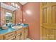 Bathroom features an antique vanity and pink walls at 3998 Holly Springs Dr # 20, Newton, NC 28658
