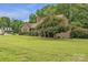 Brick home surrounded by lush greenery and mature trees at 3998 Holly Springs Dr # 20, Newton, NC 28658