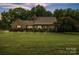 Charming brick home featuring manicured lawn, lush landscaping and mature trees at 3998 Holly Springs Dr # 20, Newton, NC 28658