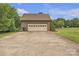 Detached brick garage with an extended driveway and lots of greenery around at 3998 Holly Springs Dr # 20, Newton, NC 28658