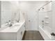 Modern bathroom featuring double sinks, a large mirror, and a shower-tub combo, perfect for everyday convenience at 4026 Honey Locust Dr, Charlotte, NC 28215