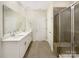 Bright bathroom features a double sink vanity, large mirror and tiled shower at 4026 Honey Locust Dr, Charlotte, NC 28215