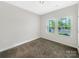Cozy bedroom with neutral carpet and two windows offering natural light at 4026 Honey Locust Dr, Charlotte, NC 28215