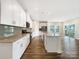 Beautiful kitchen features white cabinets, stainless steel appliances, large island and hardwood floors at 4026 Honey Locust Dr, Charlotte, NC 28215
