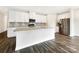 Modern kitchen features white cabinetry, stainless steel appliances, a large island, and elegant countertops at 4026 Honey Locust Dr, Charlotte, NC 28215