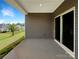 Covered patio with a view of a well-maintained backyard, offering a tranquil outdoor retreat at 4026 Honey Locust Dr, Charlotte, NC 28215