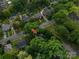 The aerial view displays the property surrounded by trees in a well-established neighborhood at 411 Hanna St, Gastonia, NC 28052