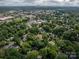 The aerial shot presents the property within a green residential area, indicated by an arrow at 411 Hanna St, Gastonia, NC 28052