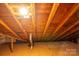 This attic has wooden beams and a floor and an access to the home's ventilation system at 411 Hanna St, Gastonia, NC 28052
