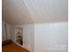 This attic has white walls and a shelf with access to the home's ventilation system at 411 Hanna St, Gastonia, NC 28052