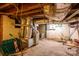 This unfinished basement features ductwork, brick walls, and cement floors at 411 Hanna St, Gastonia, NC 28052