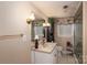 Cozy bathroom with vanity, tiled floors, and decorative mirror at 411 Hanna St, Gastonia, NC 28052