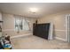 Neutral bedroom with carpet, floral curtains, and unfinished mattress at 411 Hanna St, Gastonia, NC 28052