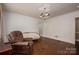 Comfortable living room featuring hardwood floors, an elegant chandelier, and vintage-style sofas at 411 Hanna St, Gastonia, NC 28052