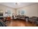 Bright sitting room features decorative antique furniture, a desk, and large window at 411 Hanna St, Gastonia, NC 28052