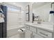 Bathroom with a white vanity, tub, shower, and toilet, creating a clean and modern space at 423 Balboa St, Matthews, NC 28104