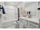 Bathroom with a shower, white vanity, and tiled floor, providing a comfortable and stylish atmosphere at 423 Balboa St, Matthews, NC 28104