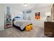 Comfortable bedroom with decorative shelves, a gray bed, and a soft carpet at 423 Balboa St, Matthews, NC 28104