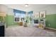 Bright Bedroom featuring two windows, soft carpet, and a white crib, ideal for a cozy and inviting space at 423 Balboa St, Matthews, NC 28104
