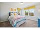Sunny bedroom with a rainbow striped bed, window views, and a cozy ambiance at 423 Balboa St, Matthews, NC 28104
