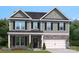 Charming two-story home with stone accents and a well-manicured lawn exudes curb appeal at 423 Balboa St, Matthews, NC 28104