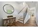 Inviting foyer with elegant wood floors, a decorative table, and a staircase at 423 Balboa St, Matthews, NC 28104