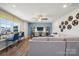 Spacious living room with a comfortable sofa, a large window, and a ceiling fan at 423 Balboa St, Matthews, NC 28104