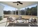 Relaxing screened-in patio with comfortable seating and views of the wooded backyard at 423 Balboa St, Matthews, NC 28104