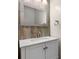 Bathroom vanity with white countertop, wood framed mirror and accent wall at 425 1St Se Ave, Hickory, NC 28602