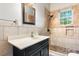 Bathroom featuring a vanity with white countertop and a tiled shower with a window at 425 1St Se Ave, Hickory, NC 28602