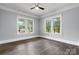 This spacious bedroom has gray walls, bright white trim, hardwood floors and two large windows at 425 1St Se Ave, Hickory, NC 28602