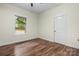 A cozy bedroom with wood floors, a window, and a white door at 425 1St Se Ave, Hickory, NC 28602