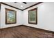 Bedroom with wood floors, two windows and wood trim at 425 1St Se Ave, Hickory, NC 28602