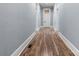 Long hallway with wood floors that leads to the front door with transom window at 425 1St Se Ave, Hickory, NC 28602